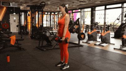 Person performing a Romanian deadlift with dumbbells.