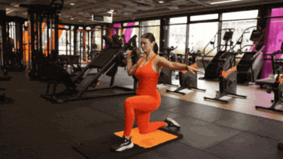 Person performing a half-kneeling overhead press with a dumbbell.