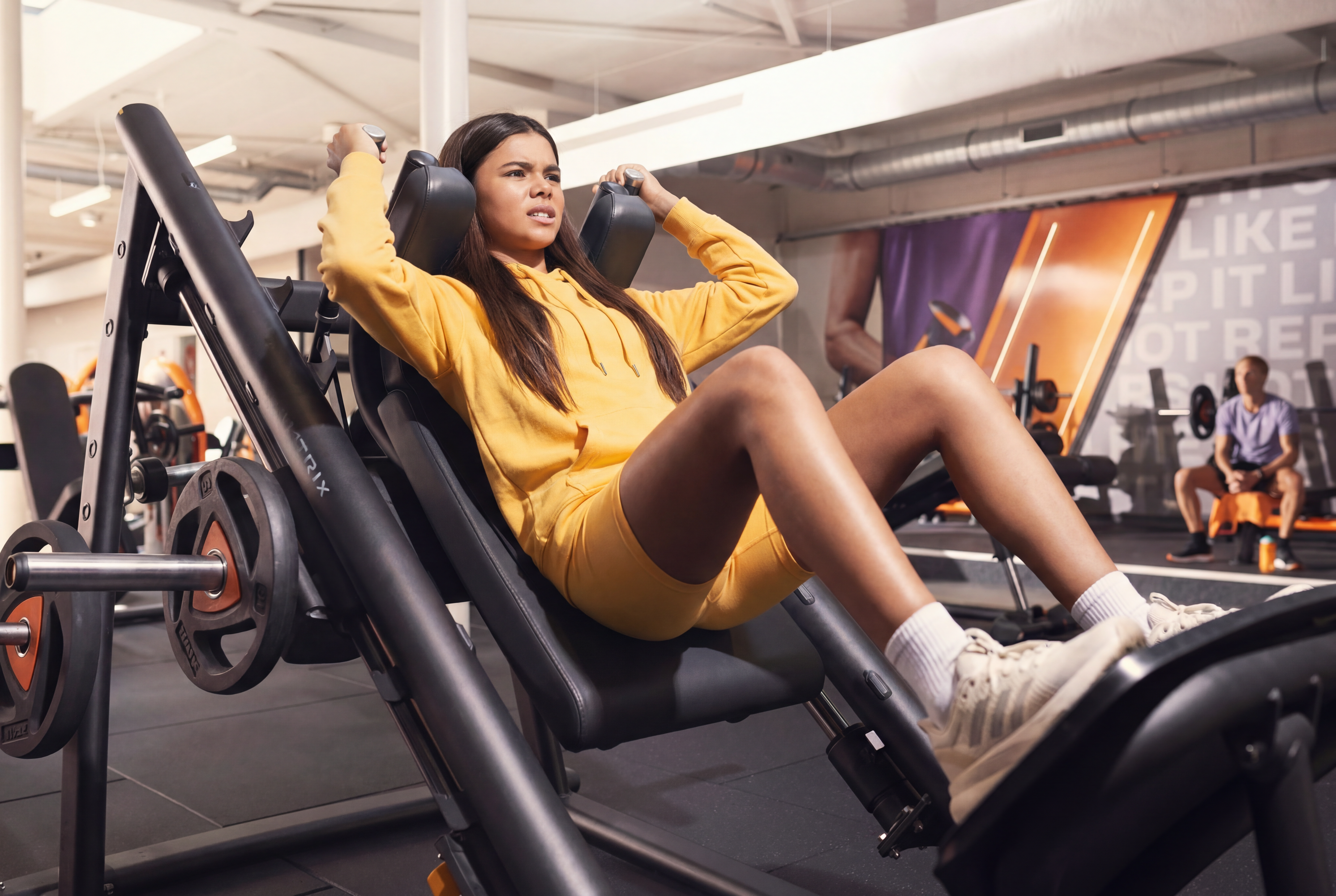 Teenager following a beginner workout plan in the gym