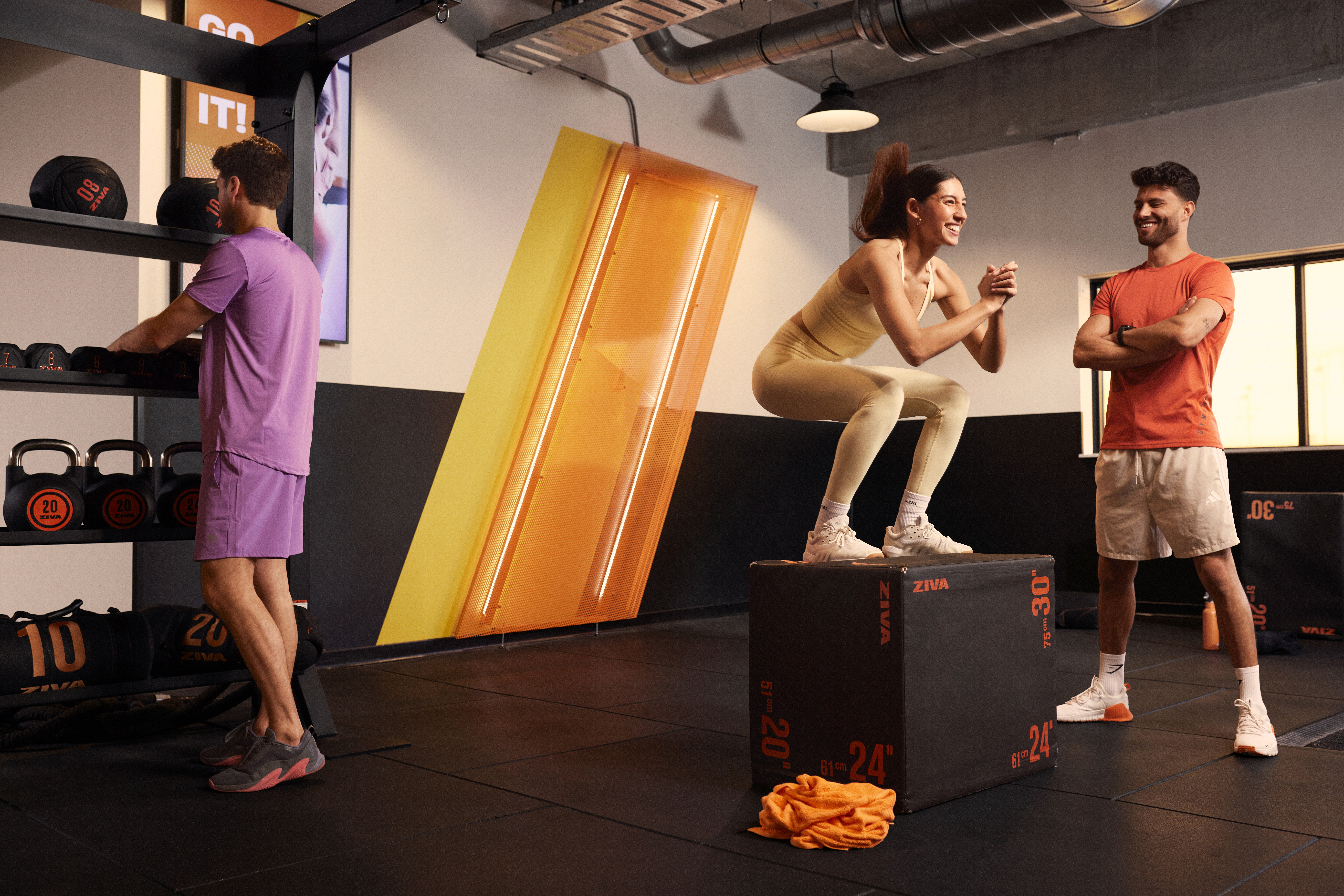Person safely practising balance exercises with support in the basic-fit