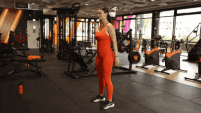 Person performing a body-weight squat with proper form.